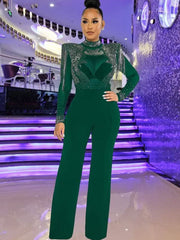 Jumpsuit mit langen Ärmeln und gepolsterten Schultern und Quasten